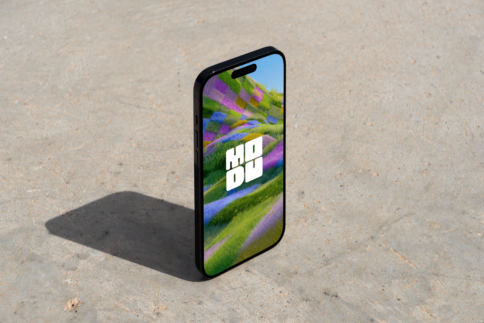 Phone standing on concrete.